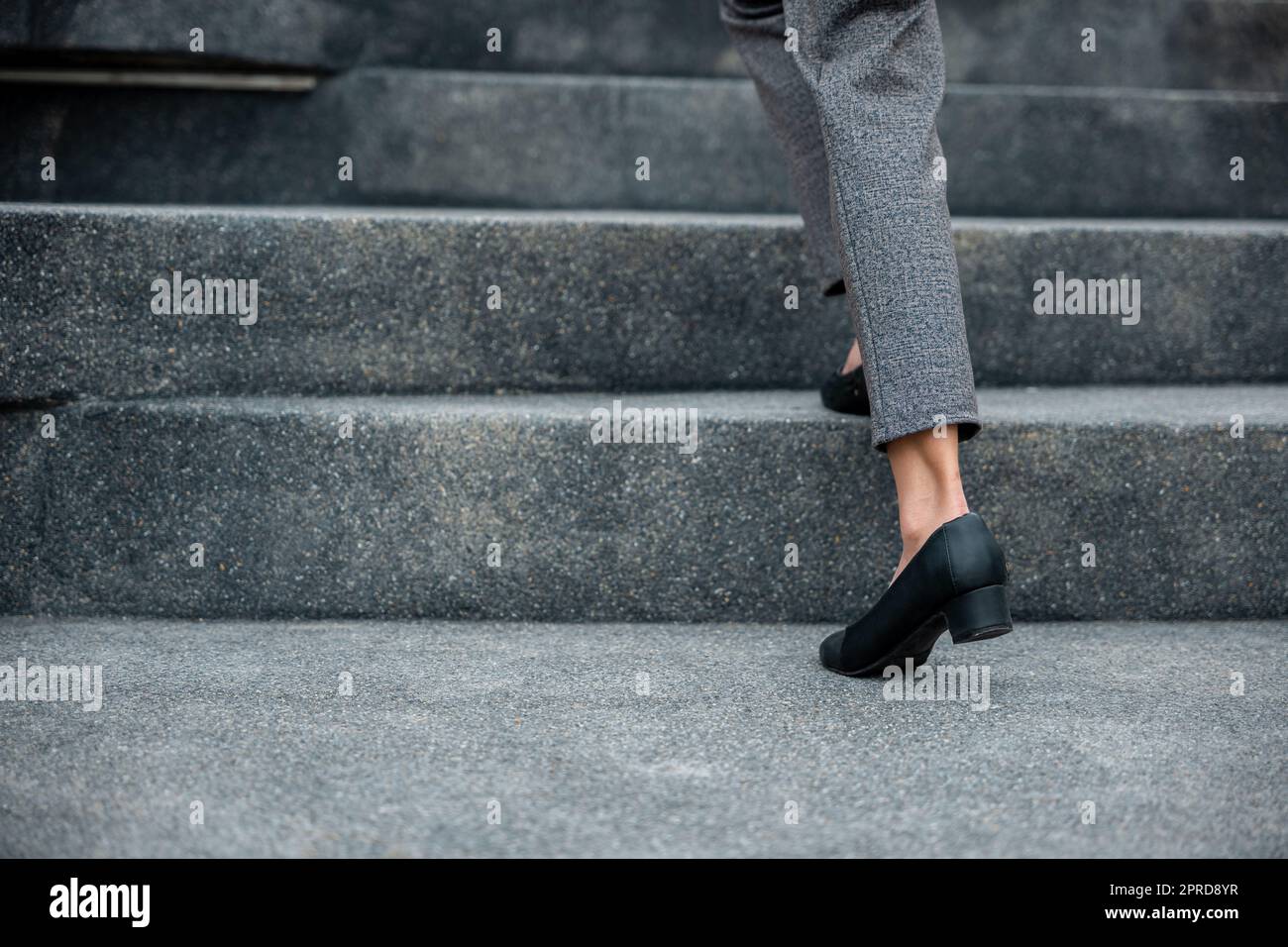 Closeup legs of businesswoman hurry up walking on stairway Stock Photo