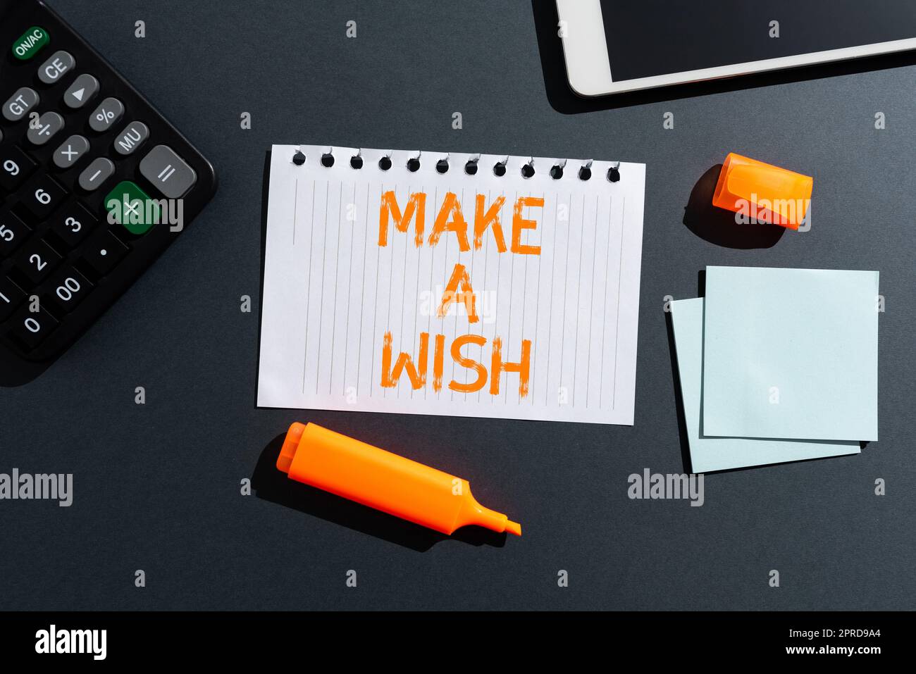 Handwriting text Make A Wish. Business overview To have dreams desires about future events Be positive Late News Written On Paper On Desk With Marker,Notes, Tablet And Calculator Stock Photo