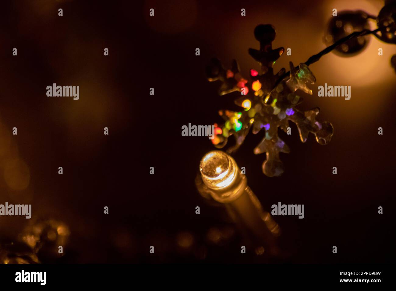 Colorful Christmas lights as multi colored chain of lights for a happy new year and holy eve as festive decoration and ornament for Christmas tree in advent time glowing bright in dark holy night Stock Photo