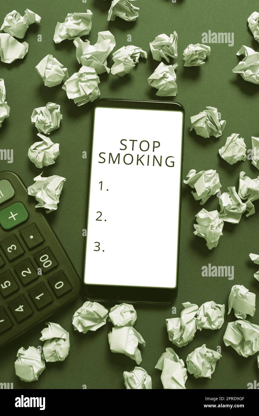 Hand writing sign Stop Smoking. Business overview Discontinuing or stopping the use of tobacco addiction Phone Screen With New Idea On It Surrounded With Paper Wraps And Calculator Stock Photo