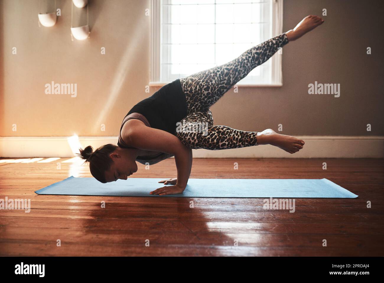 Building a fit and flexible body through yoga. a young woman practising
