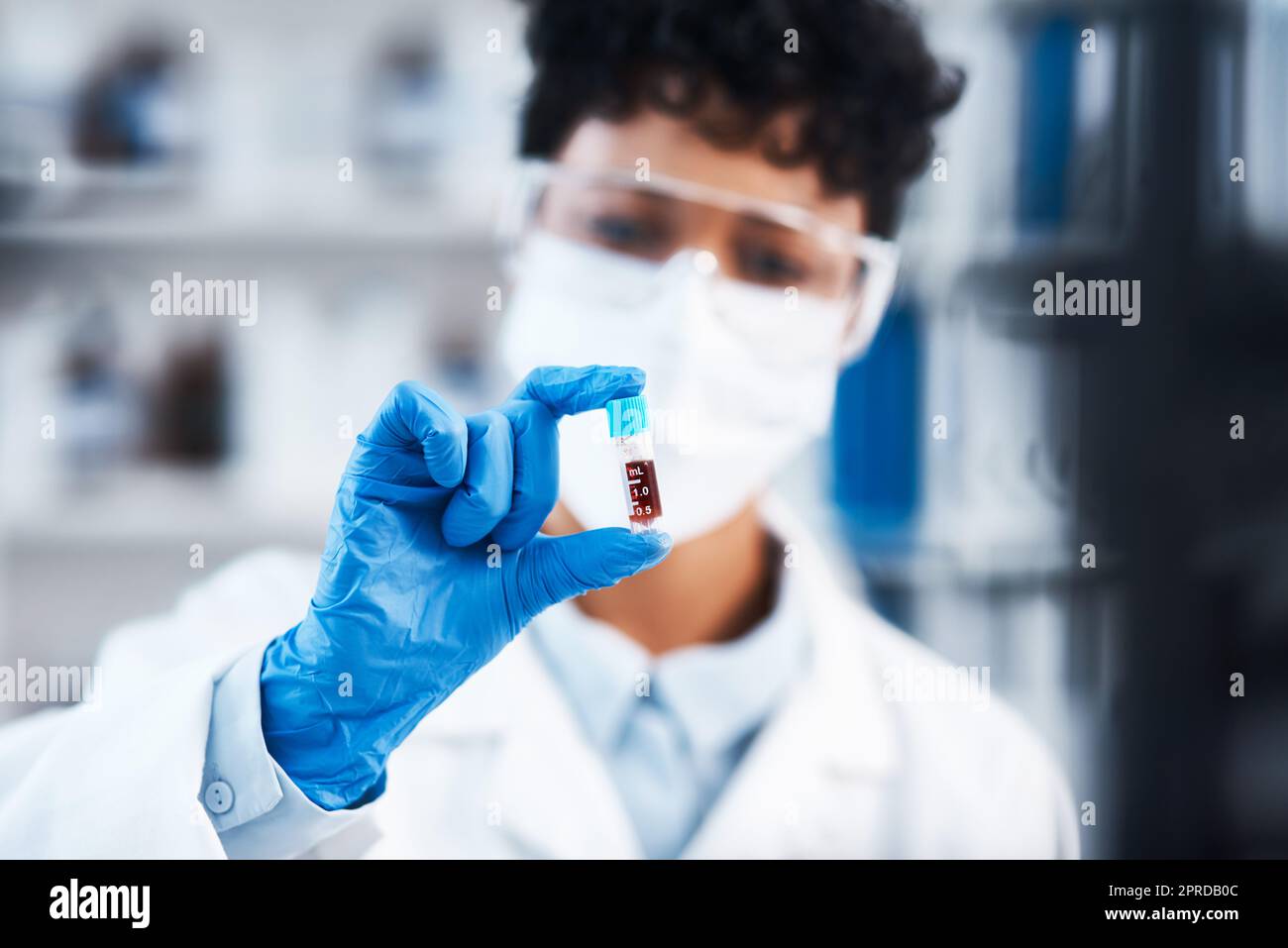 Working hard to create a cure thatll save many lives. Closeup shot of a young scientist working with samples in a lab. Stock Photo