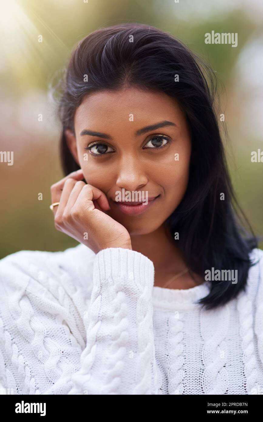 Shes perfect in every way. a beautiful young woman standing outdoors. Stock Photo