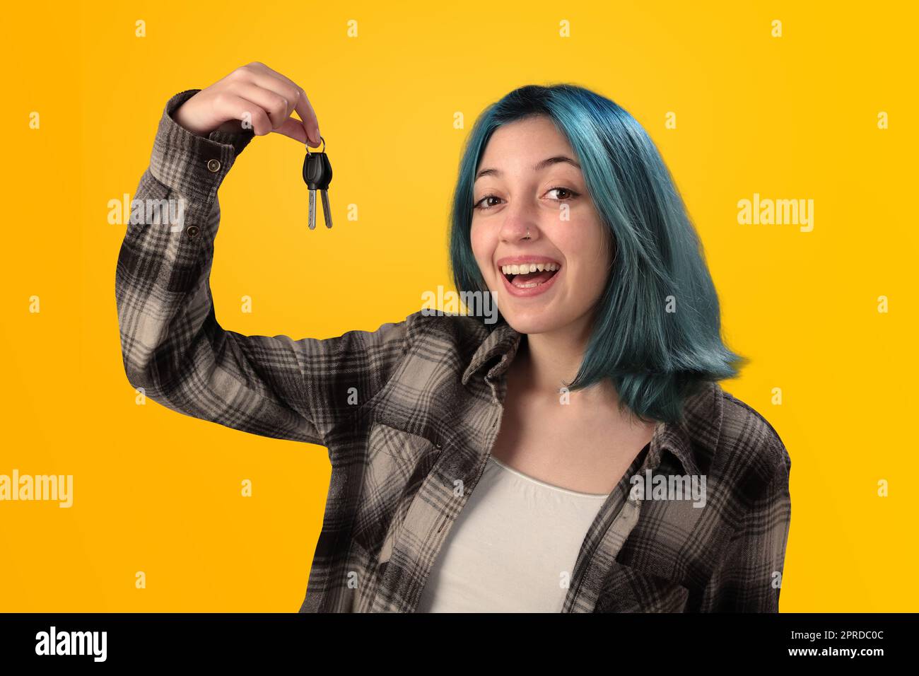 Smiling young woman student with blue hair holding keys Stock Photo - Alamy