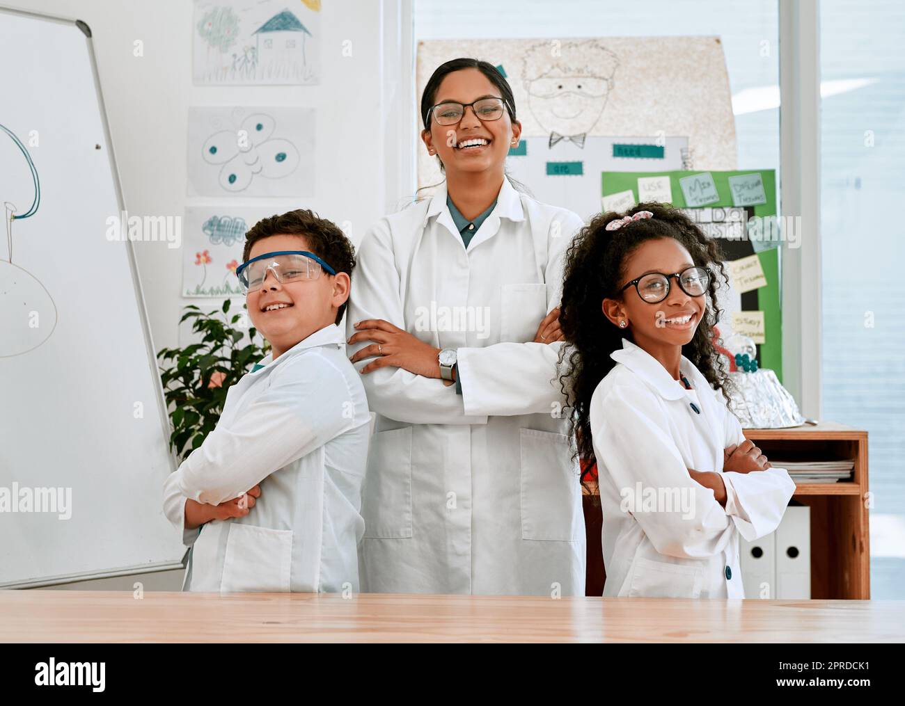We came to learn and have lots of fun. Portrait of a confident little boy and girl standing together with their teacher in science class at school. Stock Photo