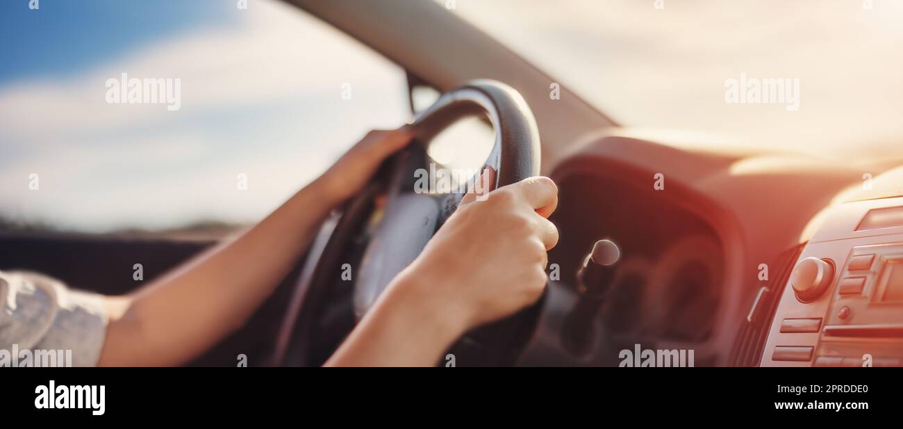 Woman's hands holding steering wheel inside car Stock Photo Alamy