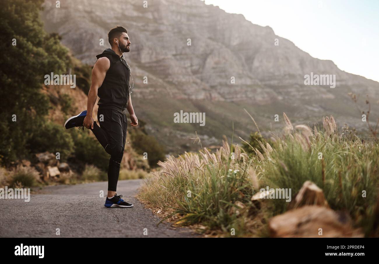 Hold onto that strong sense of determination. a sporty young man exercising outdoors. Stock Photo