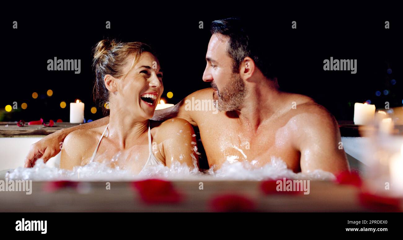 Theres definitely no other place Id rather be. an affectionate mature couple relaxing in a hot tub together at night. Stock Photo