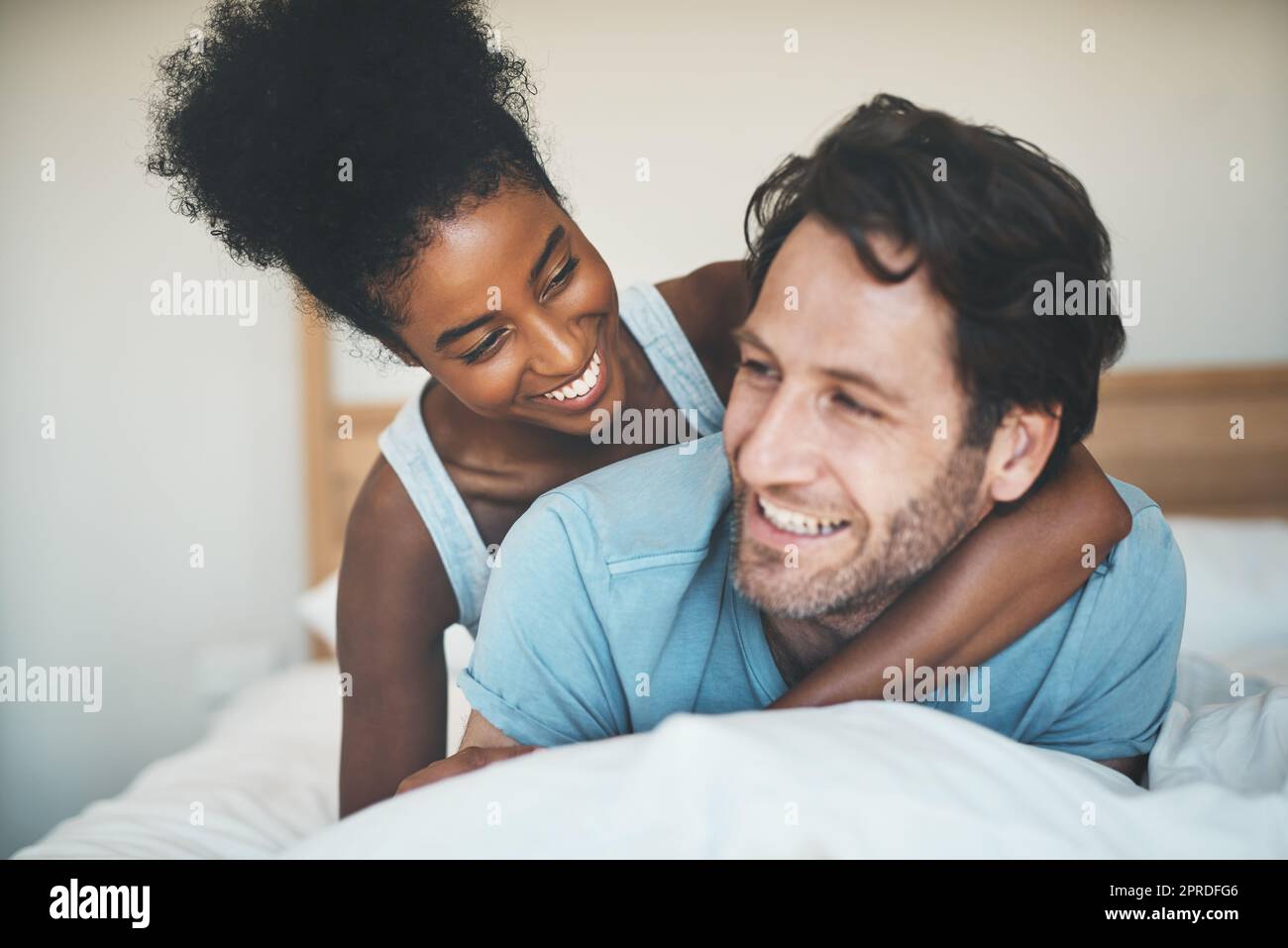 Interracial couple and bed hi-res stock photography and images