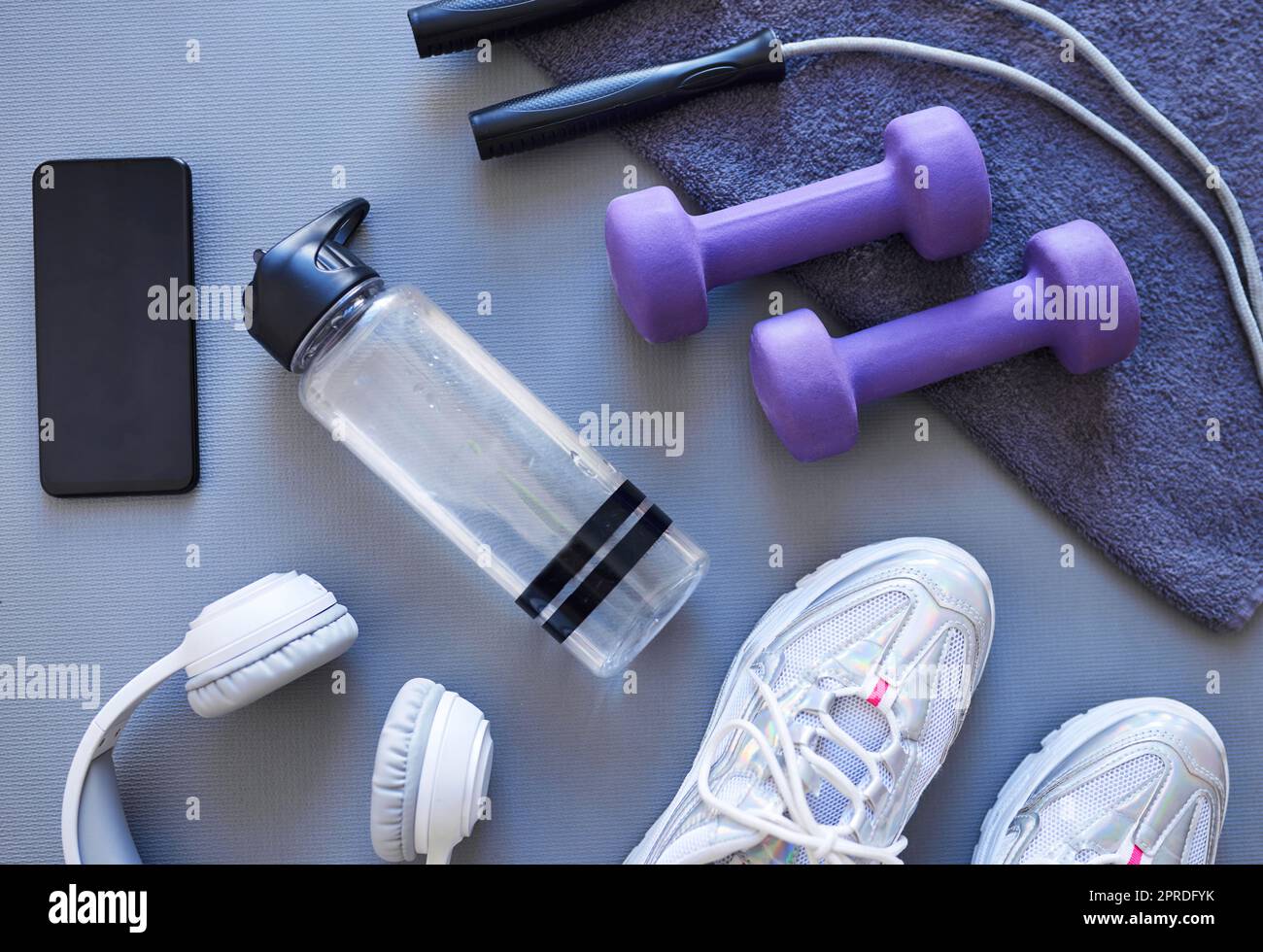 The self improvement starter pack. Studio shot of a variety of workout equipment against a grey background. Stock Photo