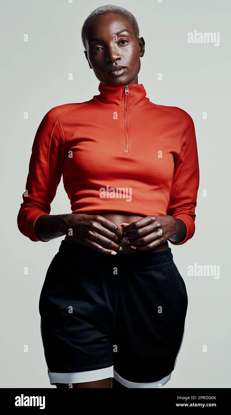 Style thats on trend for any training session. Studio shot of an attractive young woman in sportswear against a grey background. Stock Photo