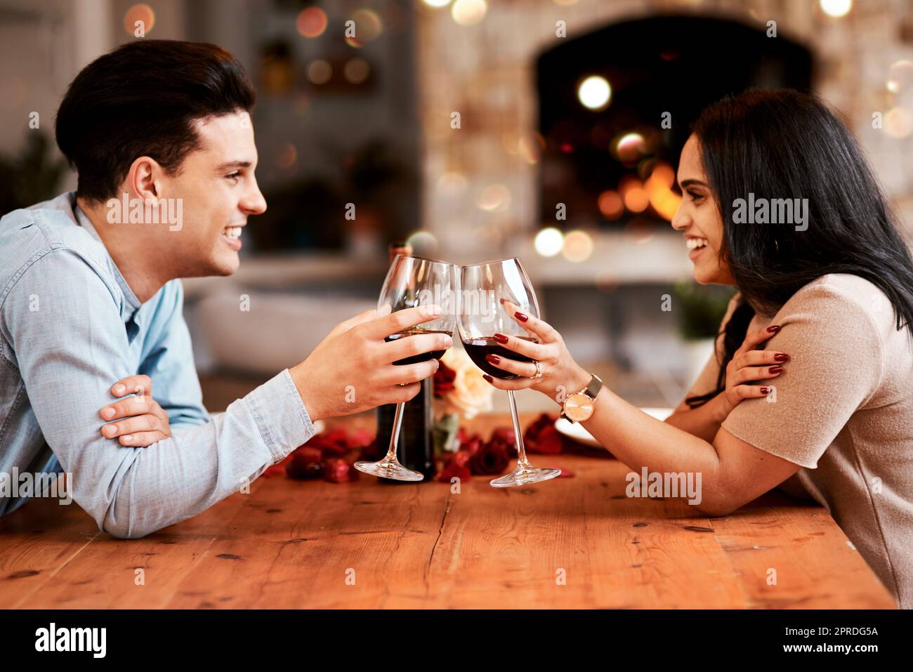 Cheers to the person I want to grow old with. a young couple having a romantic evening at home. Stock Photo