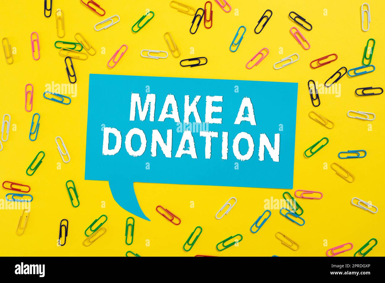 Writing displaying text Make A Donation. Business approach Donate giving things not used any more to needed showing Colorful Paperclips Placed Around Speech Bubble With Important Information. Stock Photo