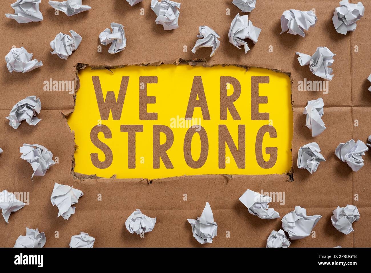 Text sign showing We Are Strong. Business approach Have great strength healthy powerful achieving everything Important Ideas Written Under Ripped Cardboard With Paper Wraps Around. Stock Photo