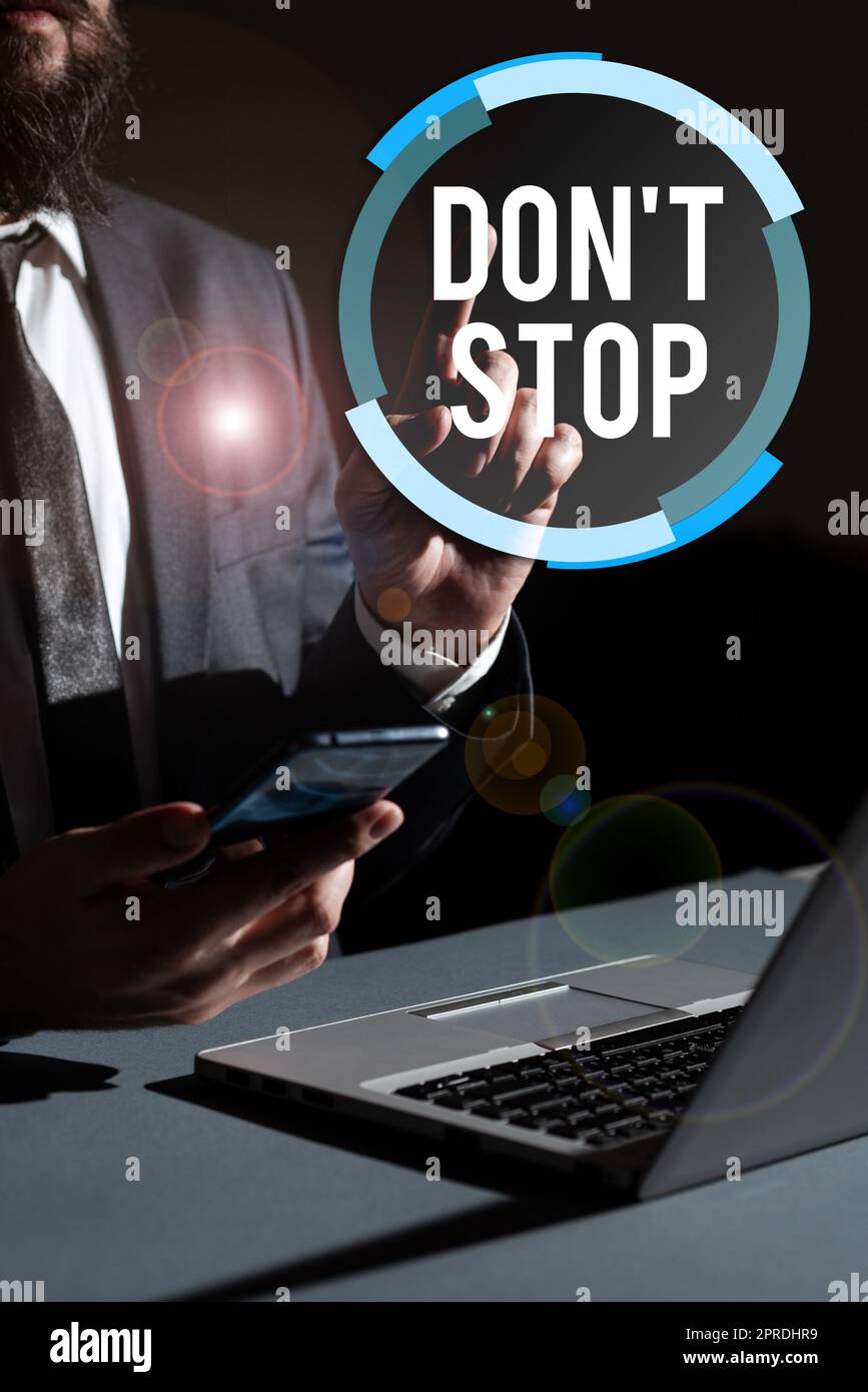 Inspiration showing sign Don T Not Stop. Business overview Continue what had been doing without rendering a delay Man Holding Mobile Phone In Hand And Pointing With One Finger On Data. Stock Photo