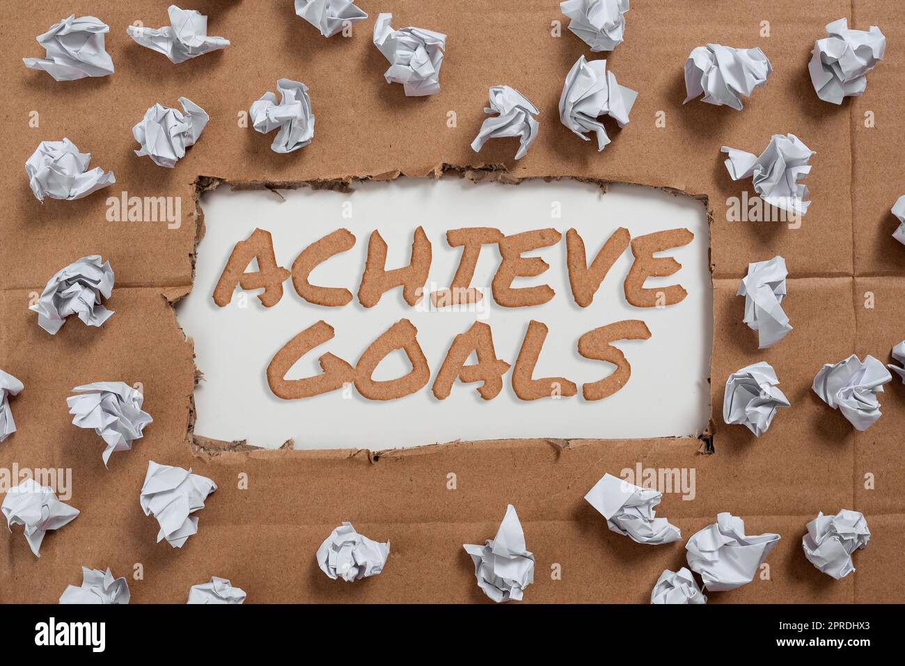 Text caption presenting Achieve Goals. Business approach Results oriented Reach Target Effective Planning Succeed Important Ideas Written Under Ripped Cardboard With Paper Wraps Around. Stock Photo