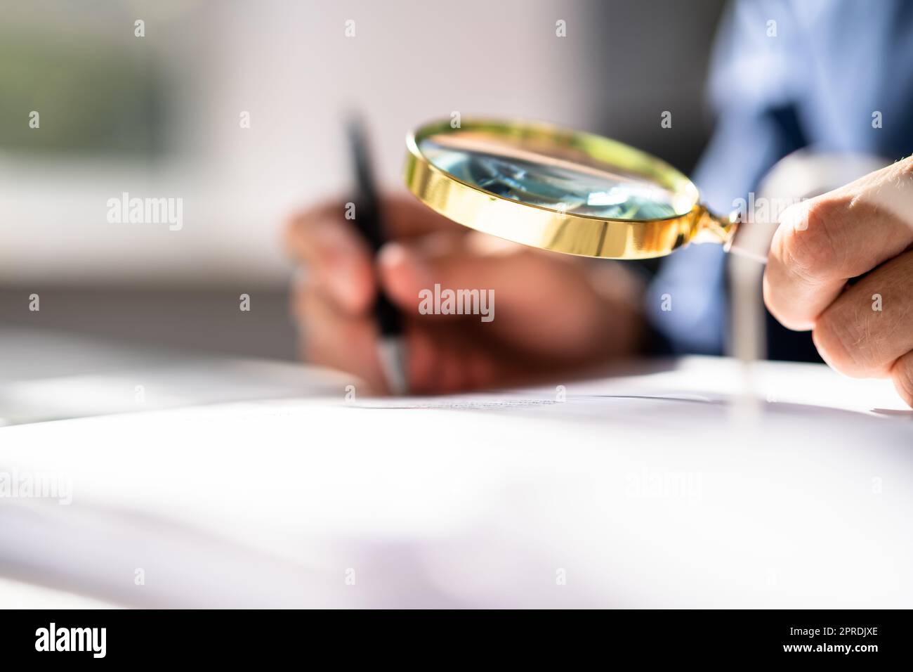 Corporate Auditor Using Magnifying Glass Stock Photo - Alamy