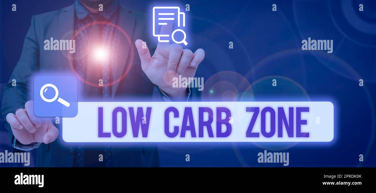 Hand writing sign Low Carb Zone. Concept meaning Healthy diet for losing weight eating more proteins sugar free Businessman With Two Hands Searching For Important Data And New Ideas. Stock Photo