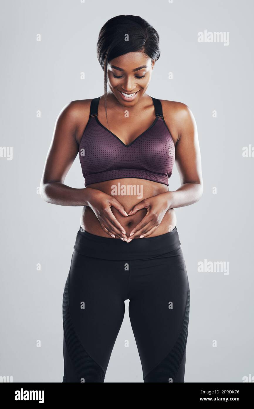 https://c8.alamy.com/comp/2PRDK76/the-biggest-love-you-can-ever-feel-is-self-love-studio-portrait-of-an-attractive-and-fit-young-woman-framing-her-stomach-with-her-hands-against-a-grey-background-2PRDK76.jpg