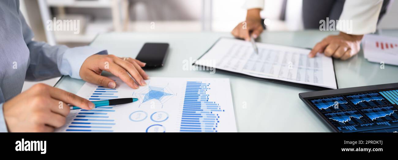 Business Partners Consulting On Marketing Chart Stock Photo Alamy