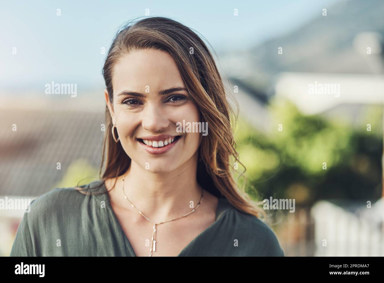 Who wouldnt fall in love with a face like that. Portrait of a cheerful young woman relaxing outdoors. Stock Photo