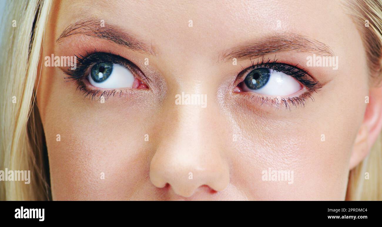 Hmmm that seems very interesting. Closeup beauty shot of a young womans eye. Stock Photo