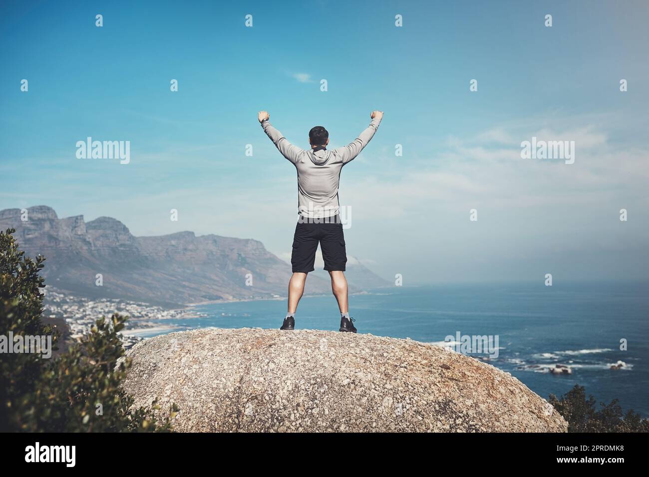 I was born to conquer the world. Rearview shot of a man standing on the top of a mountain. Stock Photo