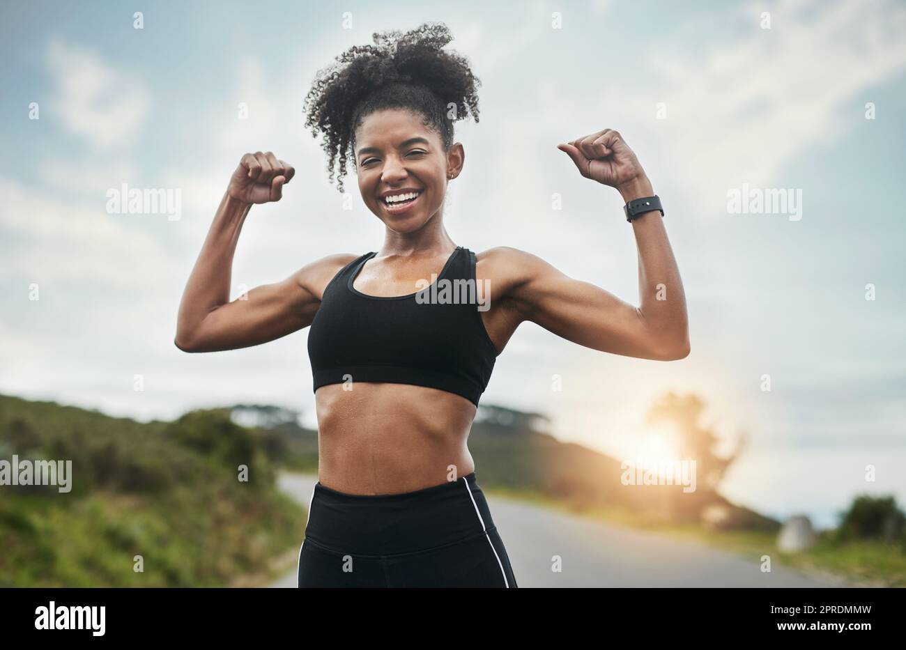 Welcome to the gun show. Cropped portrait of an attractive young sportswoman flexing her biceps outside. Stock Photo