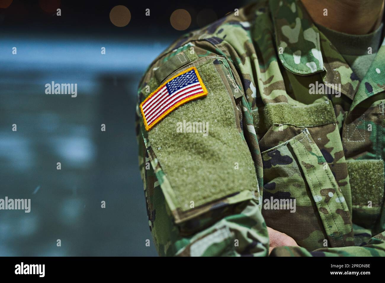 It takes someone special to serve their country. a soldier wearing camouflage fatigues with an american flag for a patch. Stock Photo