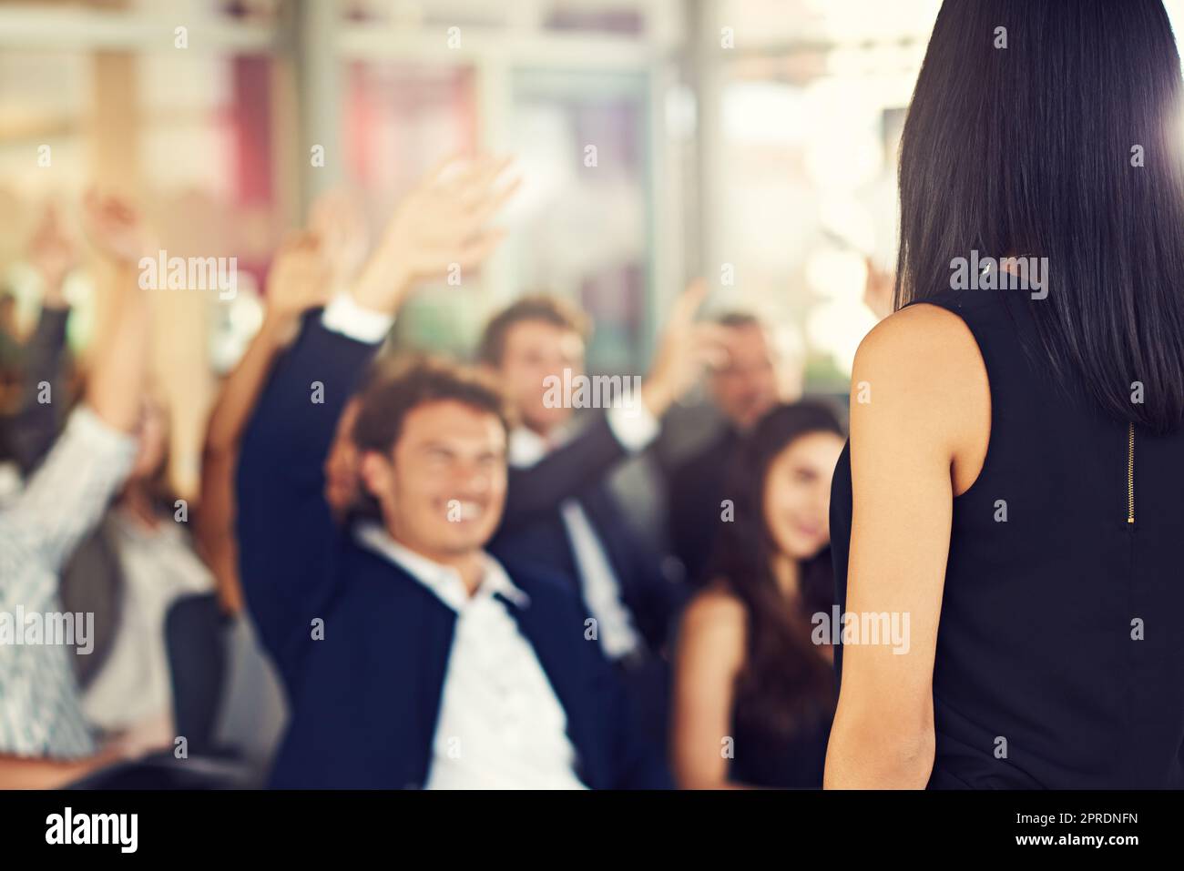 Ok Im taking questions now. businesspeople hands raised asking questions during a seminar Stock