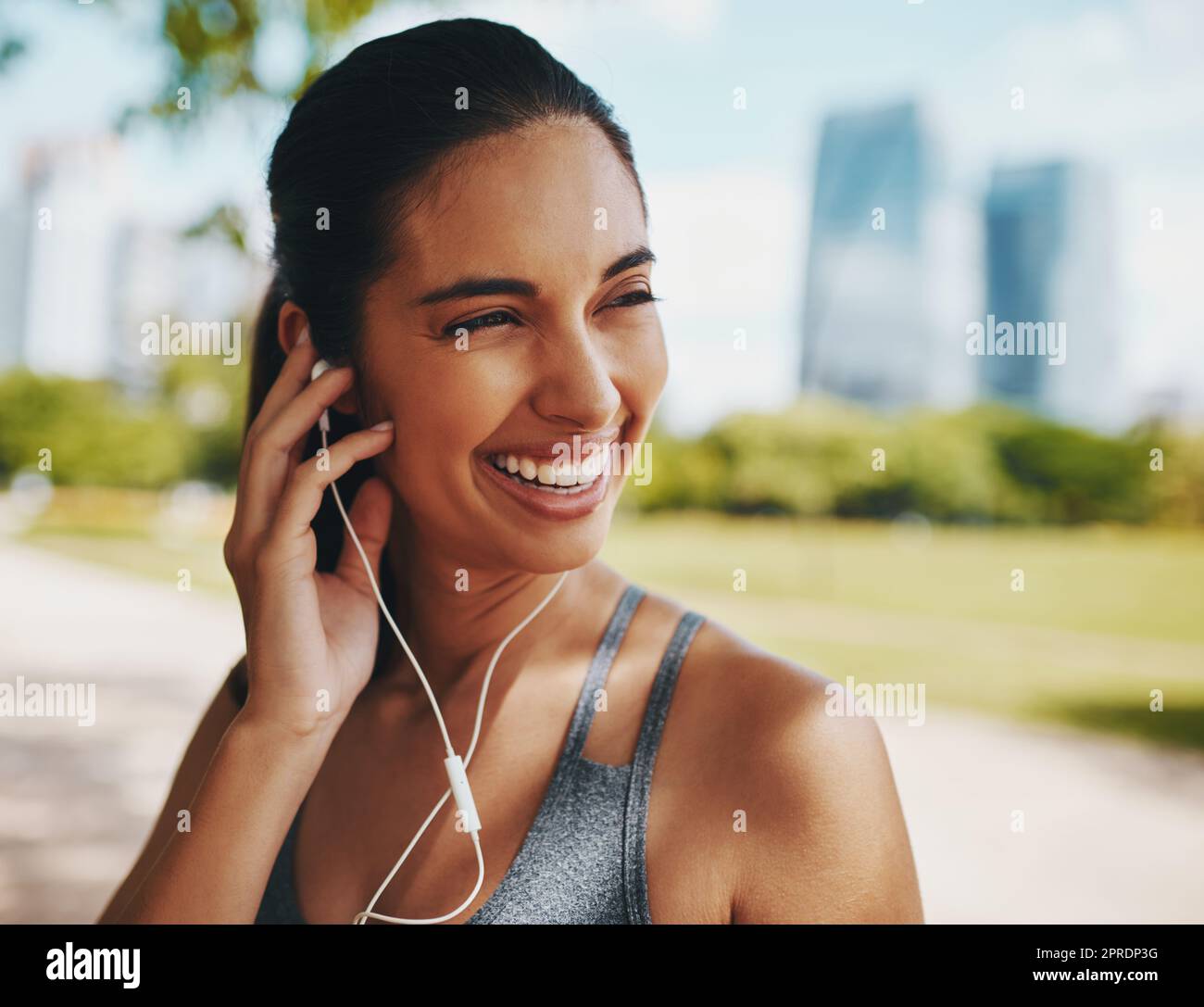 Shes found just the perfect soundtrack. an attractive young sportswoman listening to music while working out outdoors in the city. Stock Photo