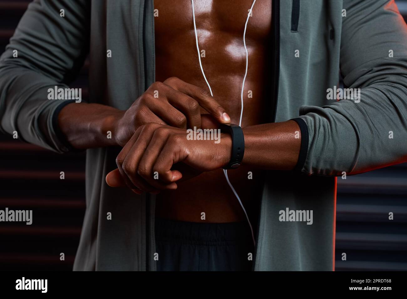 Its the perfect time to hit those monster reps. Studio shot of an unrecognizable male athlete looking at his wrist watch against a grey background. Stock Photo