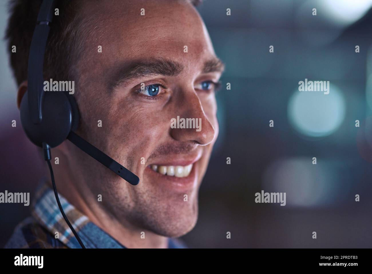 Call center agent smiling, looking happy and friendly while working in an office alone at work. Face of a positive, thinking and professional customer service agent, helpdesk operator or employee Stock Photo