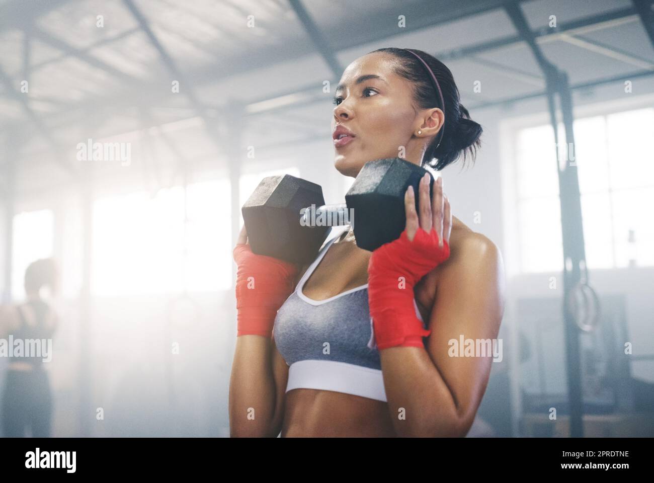 Hard work beats talent every time. a focused young sportswoman busy working out in the gym. Stock Photo