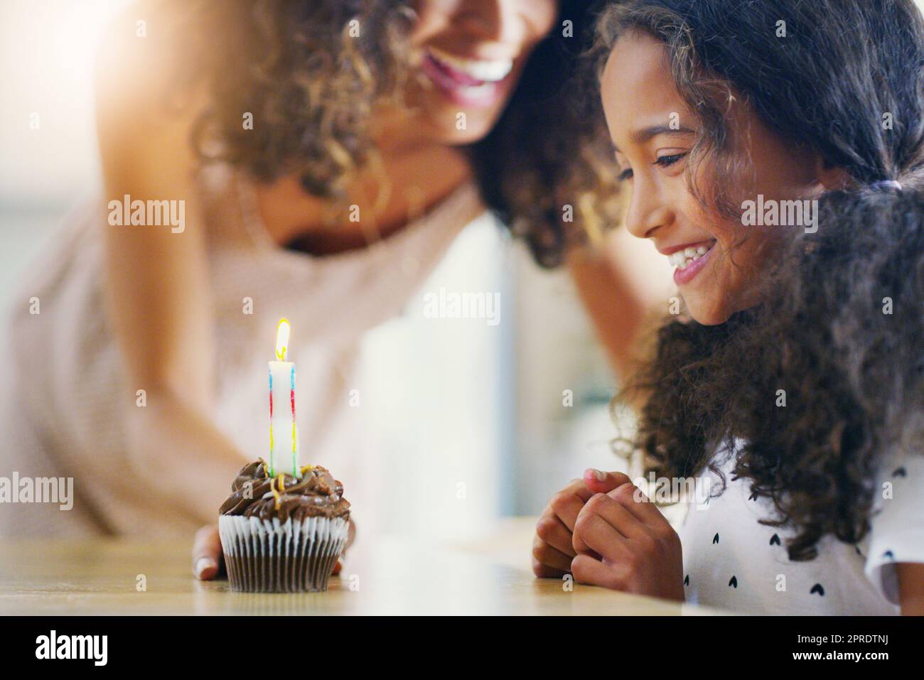 Sometimes the little things bring the most joy in life. a mother and her young daughter celebrating a birthday at home. Stock Photo