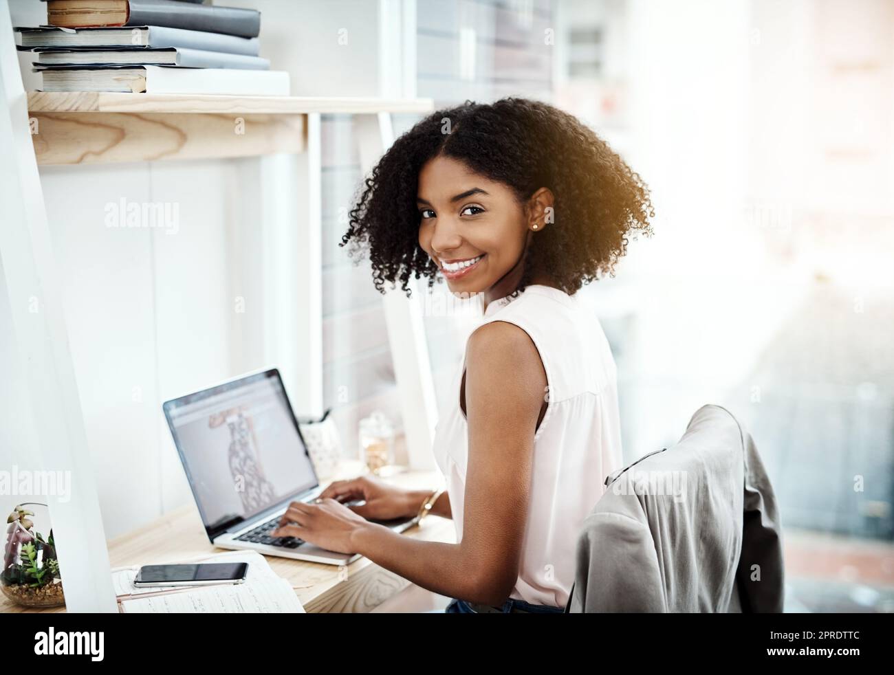 Im building something of my own. Cropped portrait of an attractive young businesswoman working on her laptop in her home office. Stock Photo