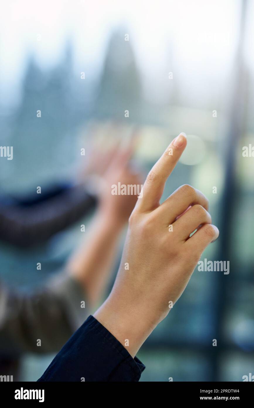 Ive got the answer. a group of unrecognizable businesspeople hands raised in an office. Stock Photo