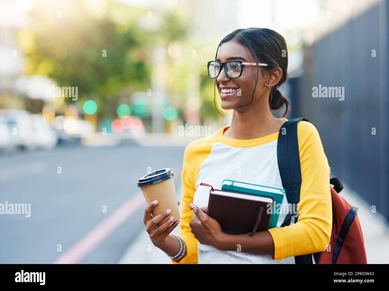 Commuting in the city to college. a young female student commuting to college in the city. Stock Photo