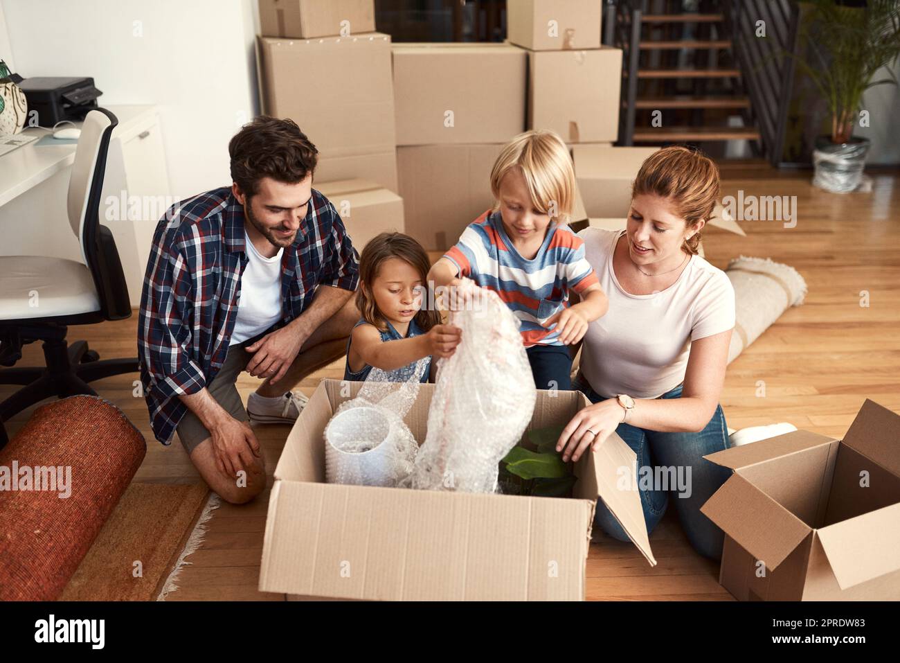 Home is where you make it. a young family on their moving day. Stock Photo