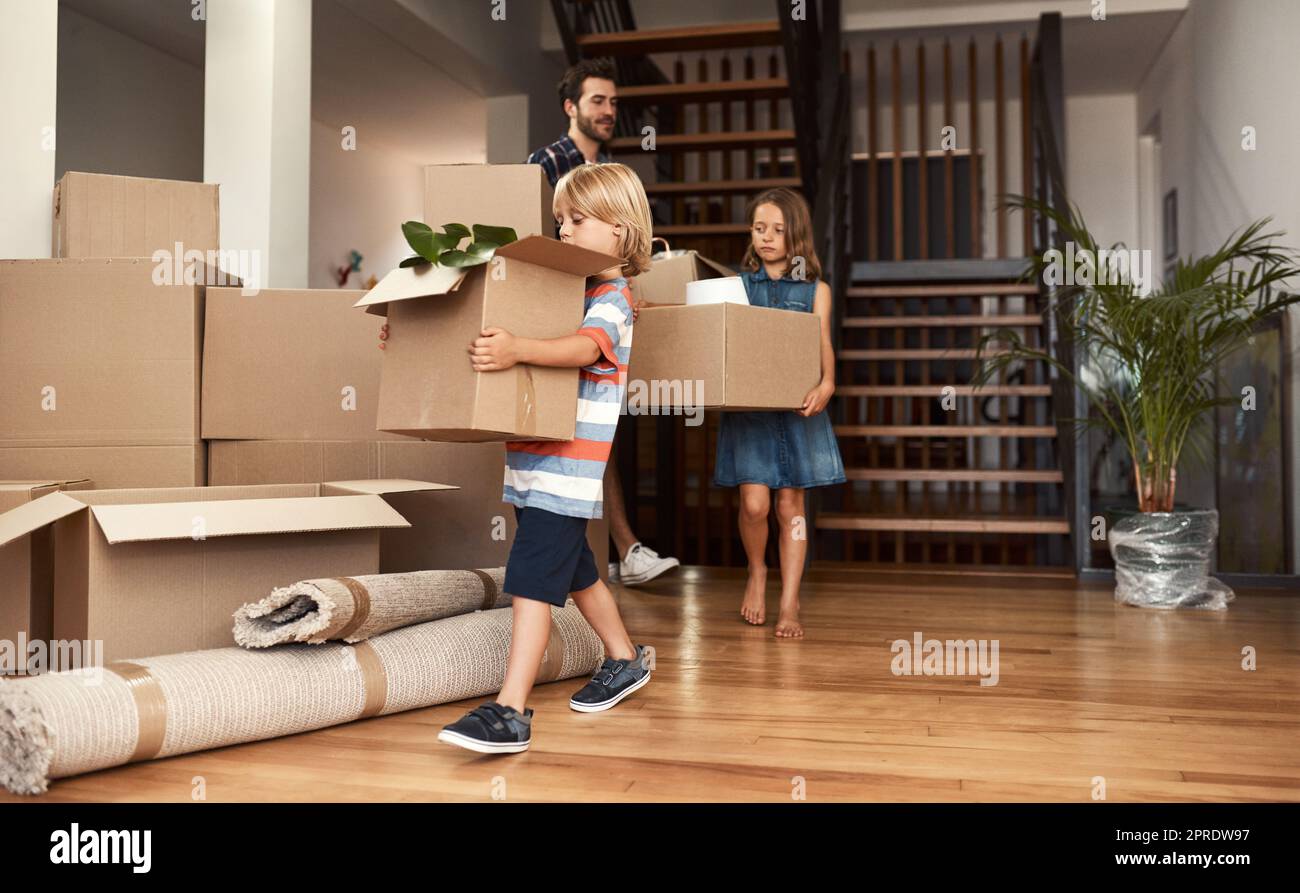 Everyone is helping out. a young family on their moving day. Stock Photo