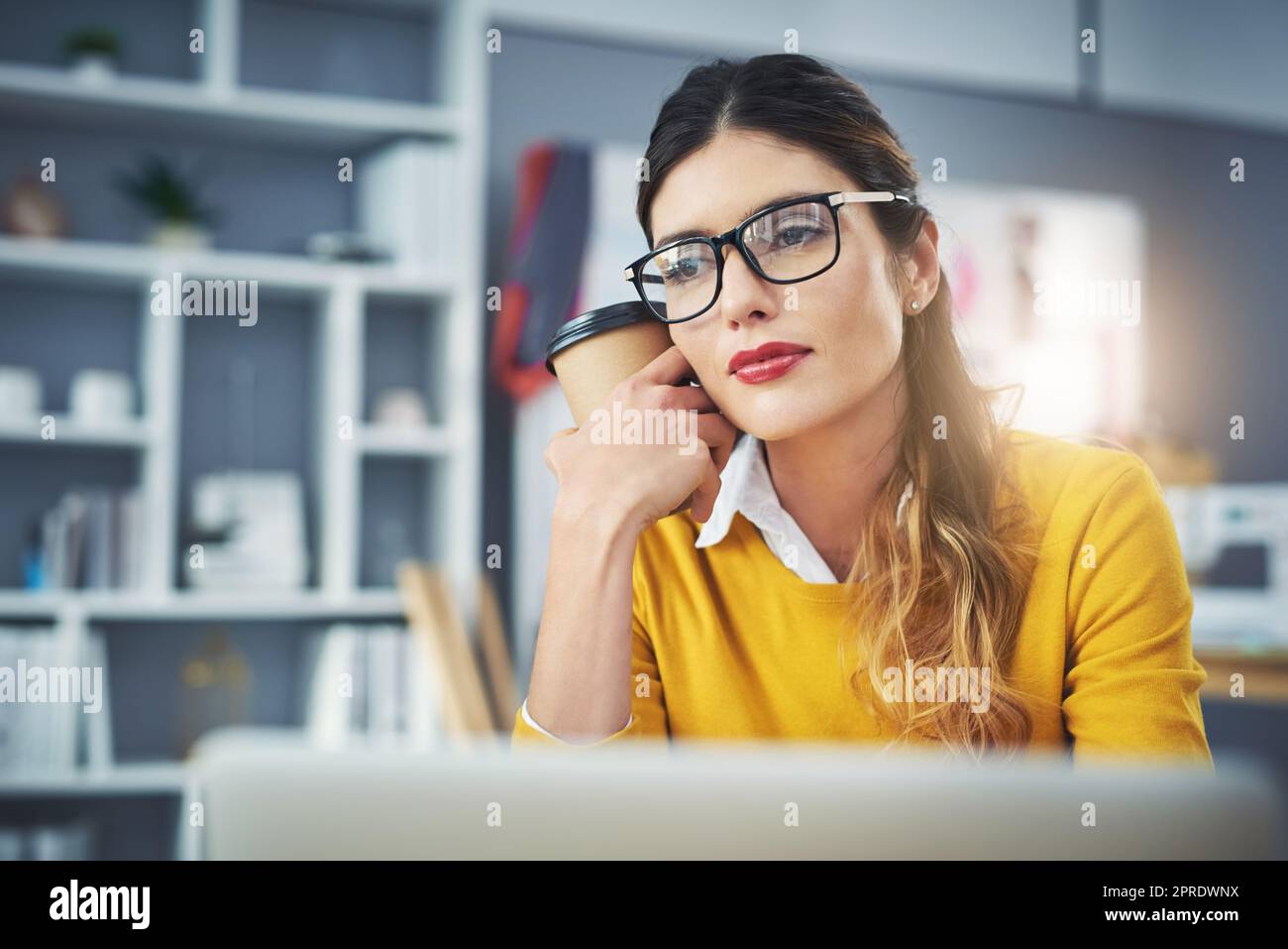 Dont quit your daydream. an attractive young fashion designer in her workshop. Stock Photo