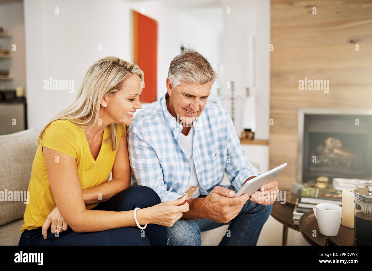 Beautiful, smiling mature couple buying online, shopping on their