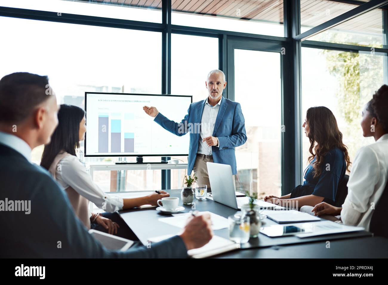 Education, training or learning on screen in business boardroom meeting to analyze data, chart or report. Manager with team of motivated executives in workshop presentation to plan vision or strategy Stock Photo