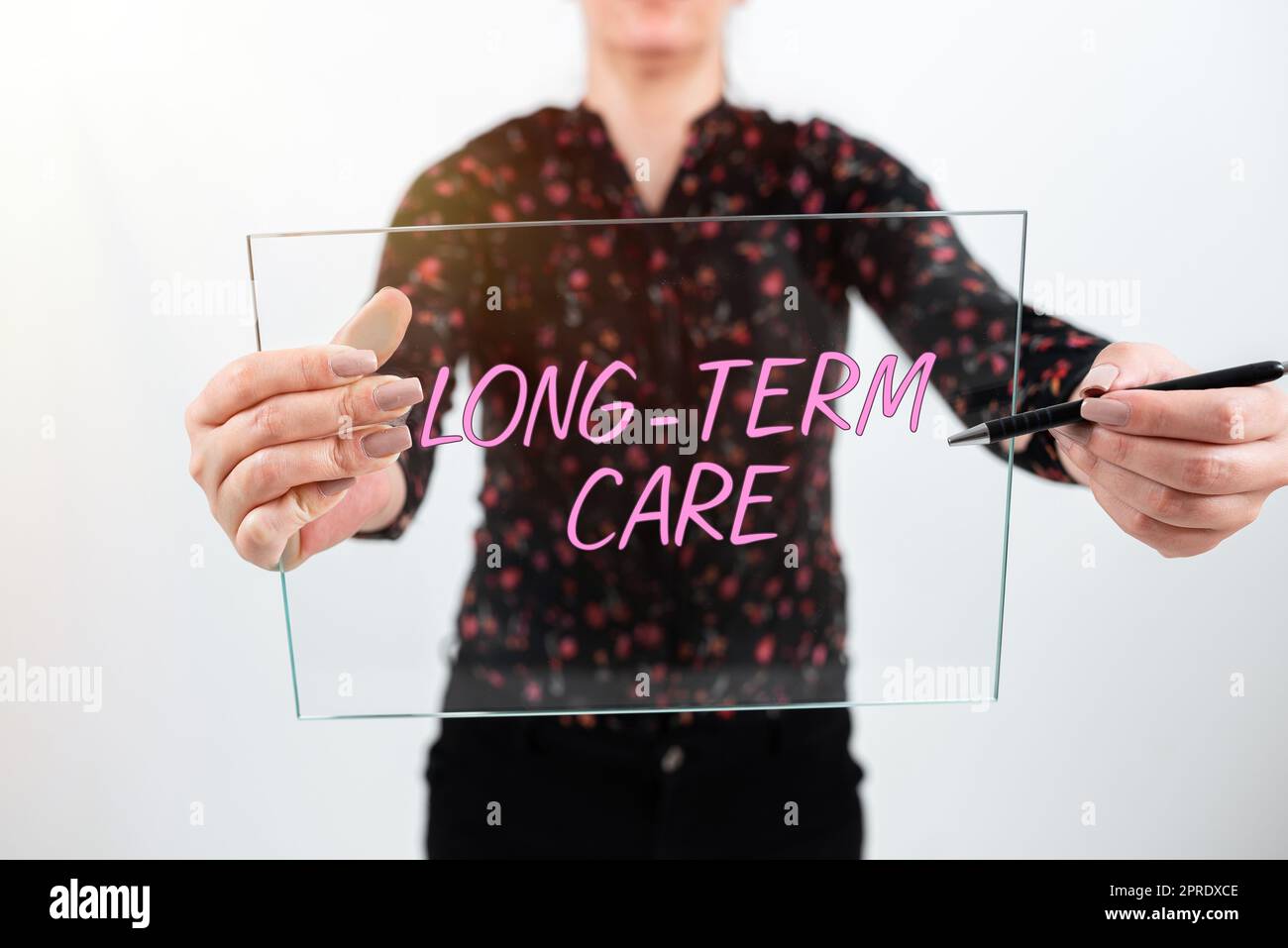 Conceptual display Long Term Care. Concept meaning Adult medical nursing Healthcare Elderly Retirement housing Doctor With Gloves Pressing On Power Button Receiving Information. Stock Photo