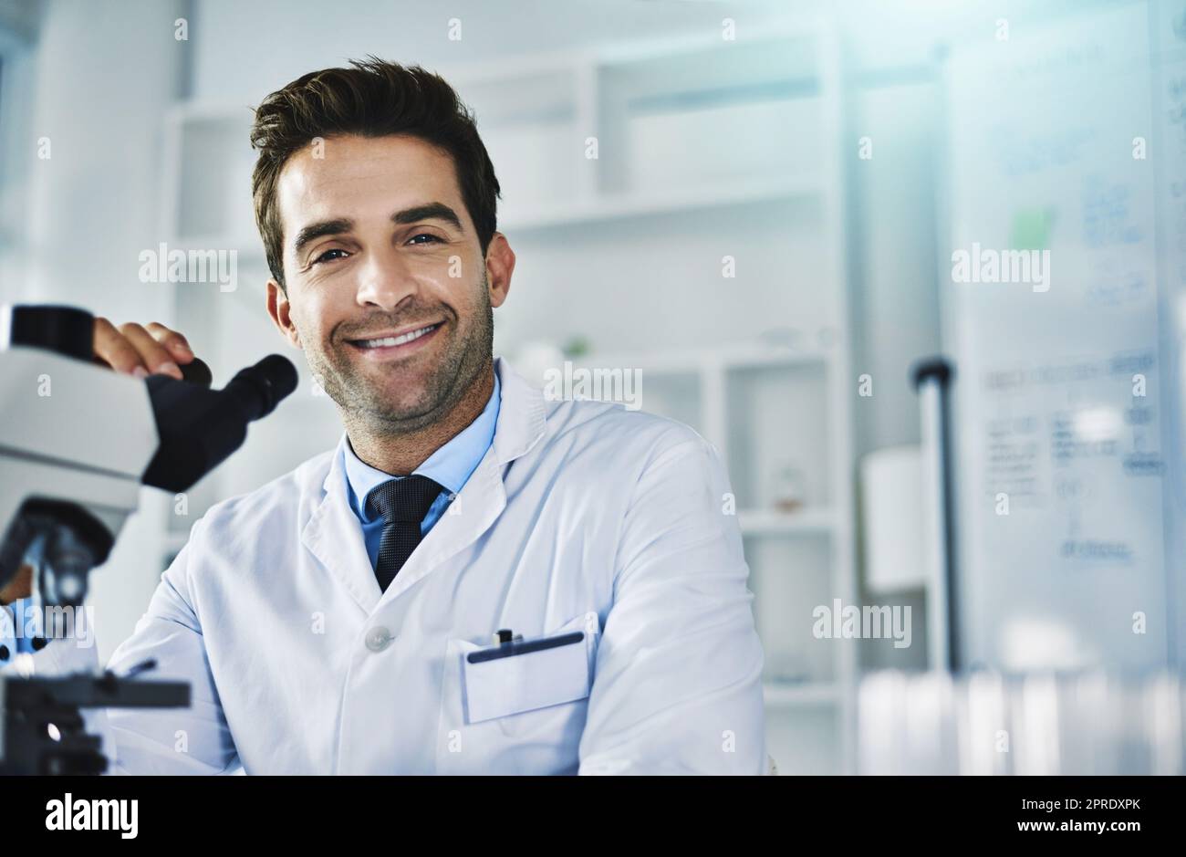 Guess who made a new breakthrough discovery. Portrait of a scientist using a microscope in a lab. Stock Photo