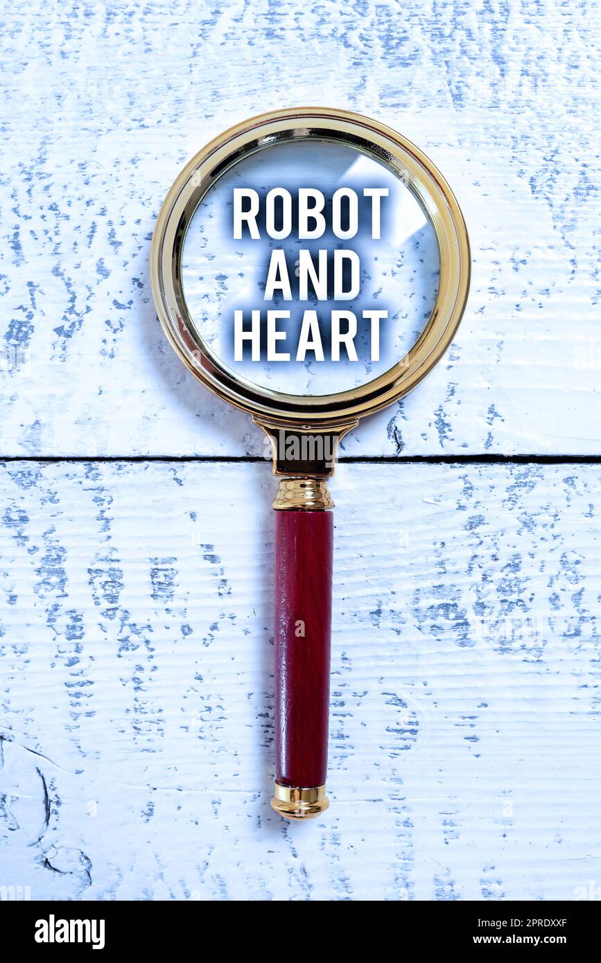 Hand writing sign Robot And Heart. Business idea Sensitivity and care behind the machine technology Young Man Showing Business Solutions In Digital Lab With Digital Technology Stock Photo