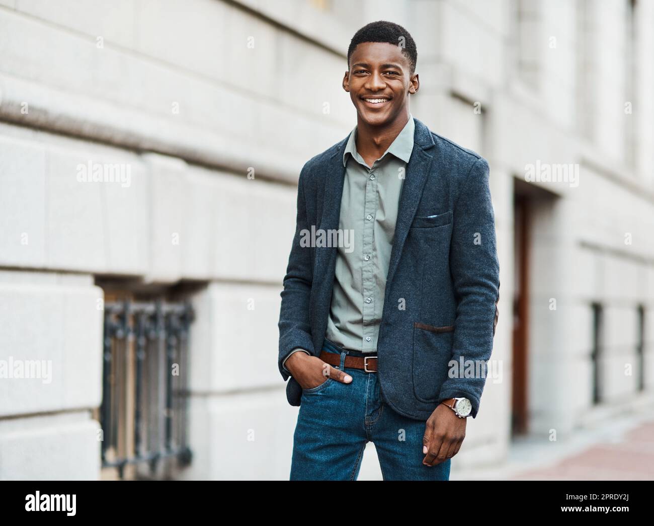 Stylish, trendy and handsome businessman walking to work in the city alone. Portrait of a cool black male entrepreneur commuting to his job and looking happy, carefree and cheerful in the morning Stock Photo