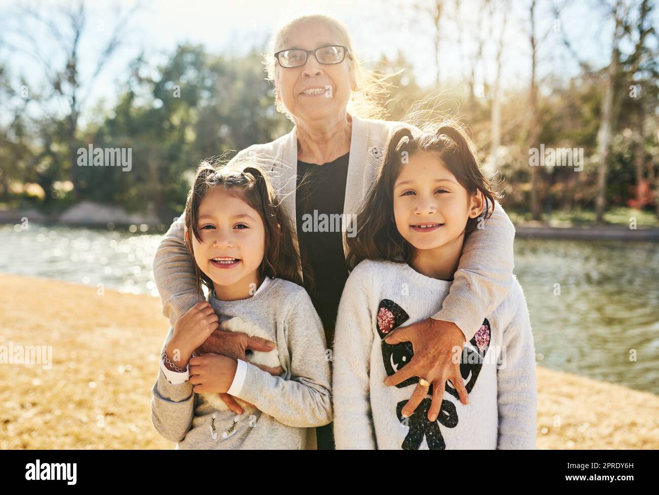 We have so much to learn from our grandmother. Portrait of a grandmother spending time with her adorable granddaughters outdoors. Stock Photo