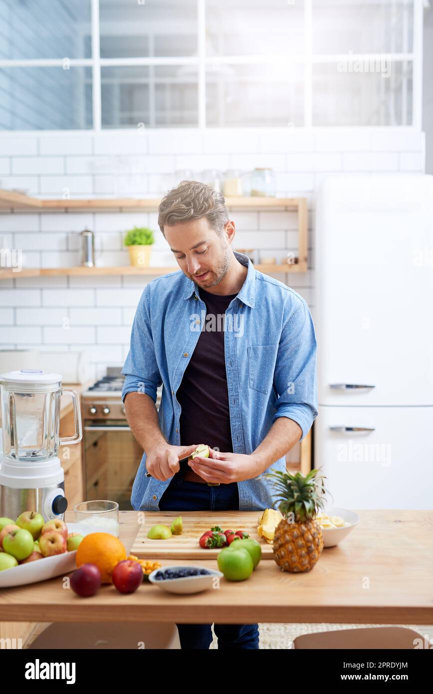 As healthy as it is tasty. a young man making a health smoothie at home. Stock Photo