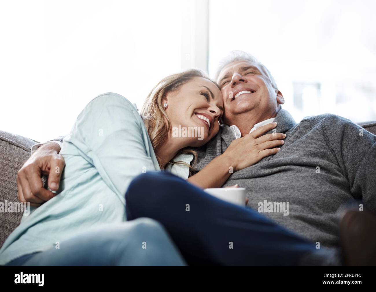 Sit back, relax and enjoy these leisurely years. a mature couple relaxing on the sofa together